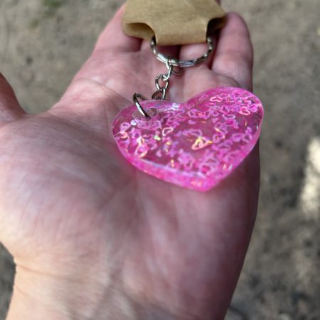 Resin heart shape keyring with small pink hearts and sparkly glitter