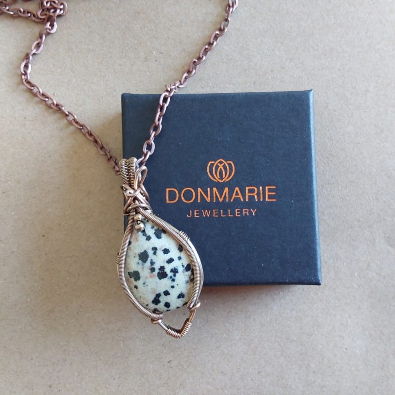 Antiqued copper wire wrapped Dalmation Jasper cabochon pendant with 18 inch copper colour chain and free Tracked postage.
