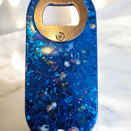 Blue beach themed nautical resin bottle opener with starfish, shells & glitter