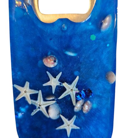 Blue beach themed nautical resin bottle opener with starfish, shells & glitter