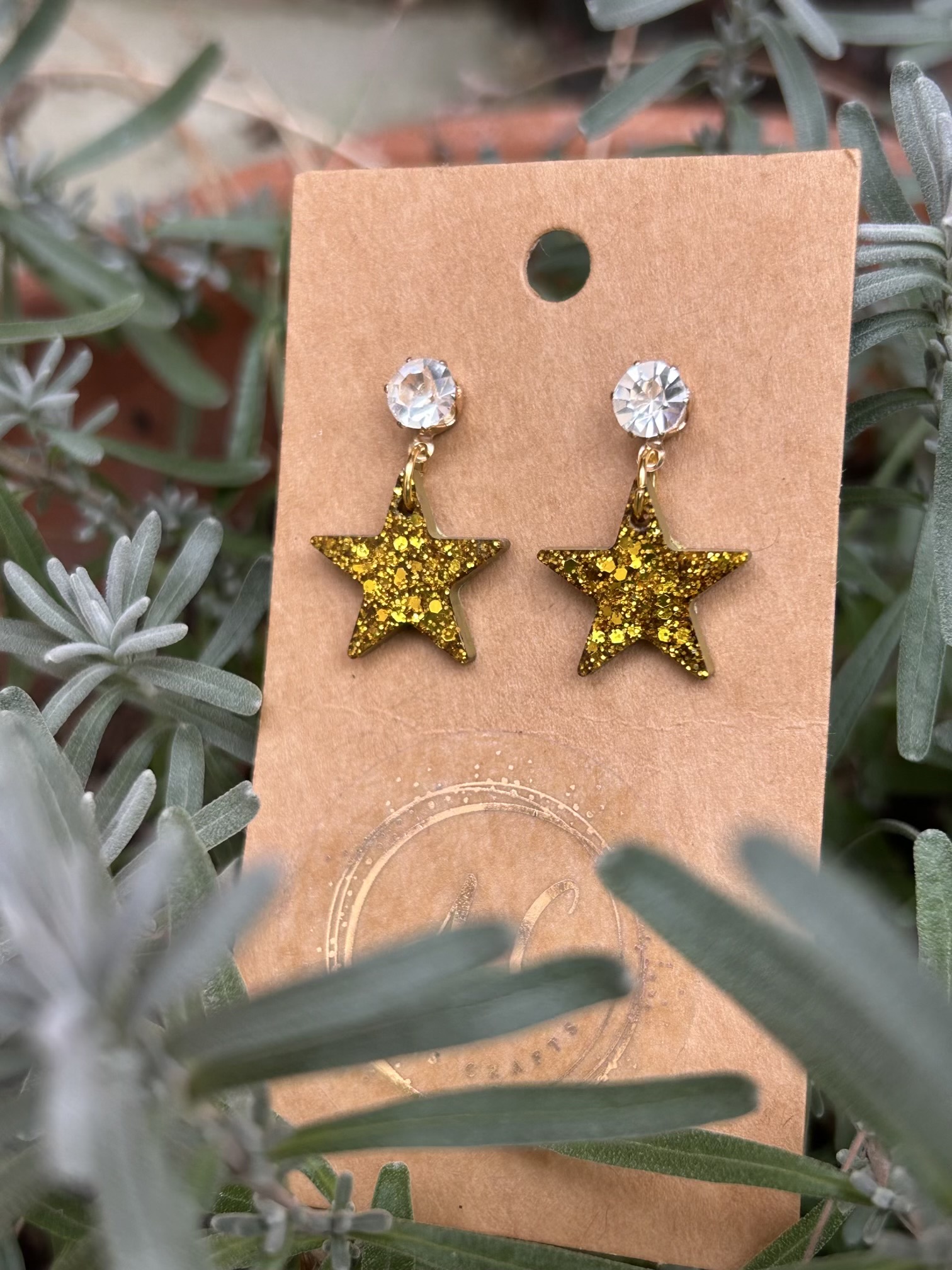 Gold glittery resin star stud earrings