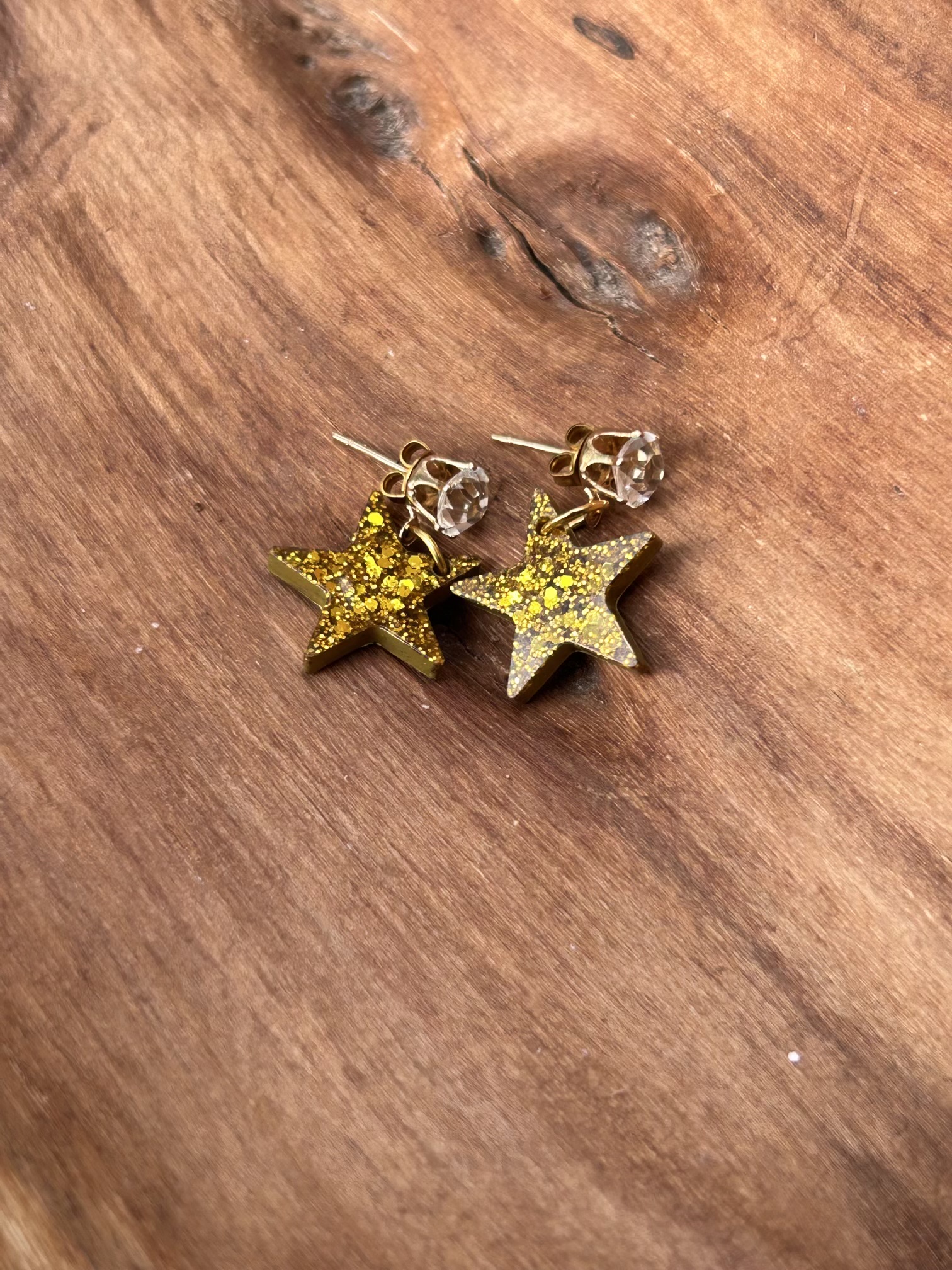 Gold glittery resin star stud earrings