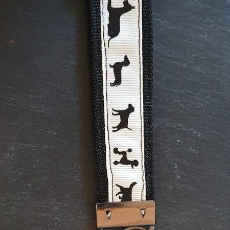 Dog breeds print fabric key fob with a cream background
