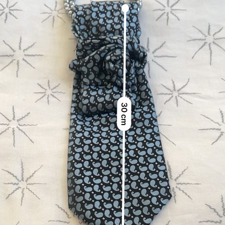Handmade, necktie accessory in a lovely, funky blue pattern tied with dark silver pearls