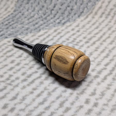 Hand turned bottle stopper made from oak with a chrome teardrop base
