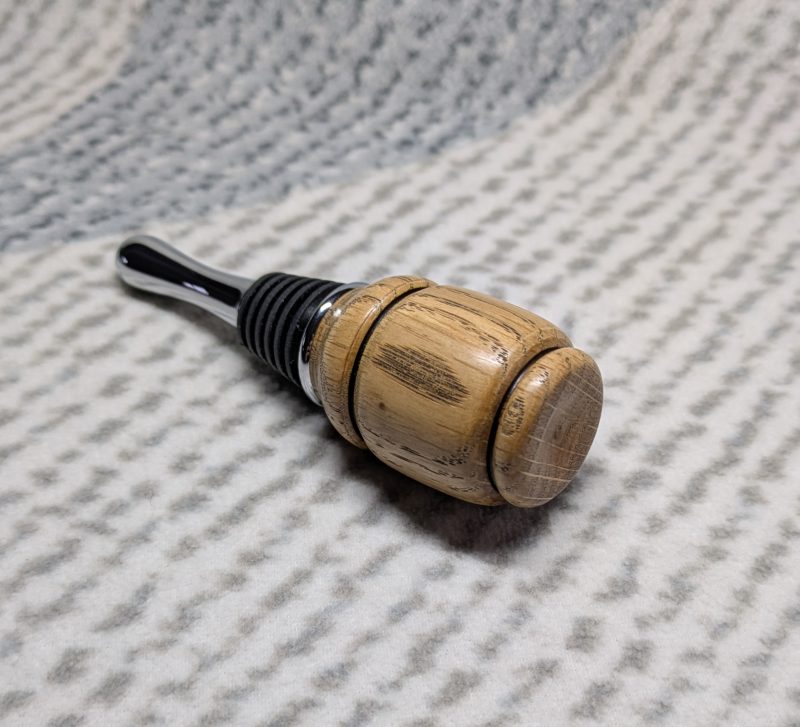 Hand turned bottle stopper made from oak with a chrome teardrop base