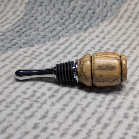 Hand turned bottle stopper made from oak with a chrome teardrop base