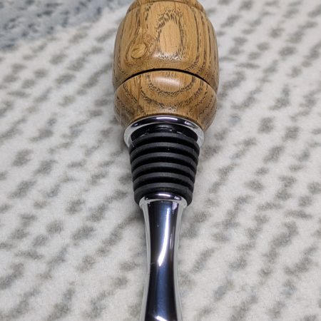 Hand turned bottle stopper made from oak with a chrome teardrop base