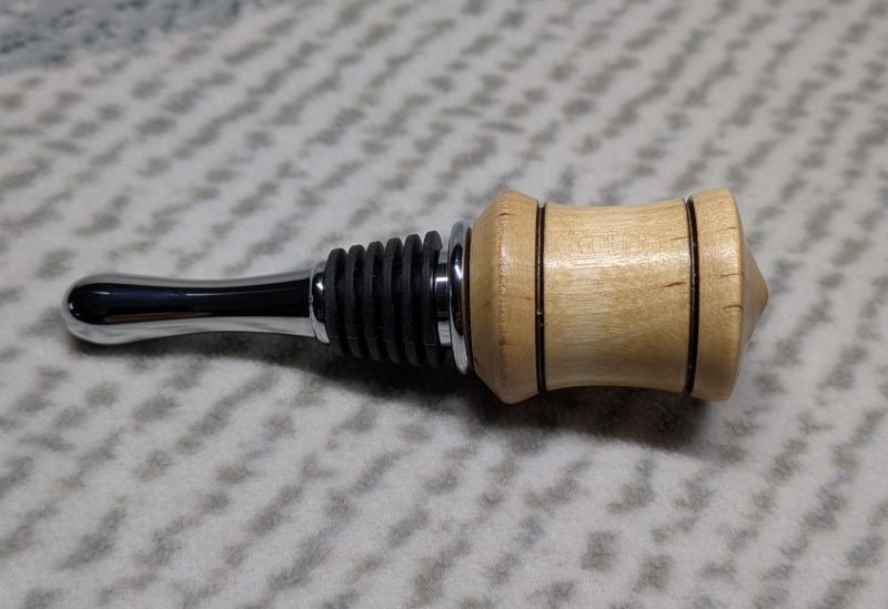 Hand turned bottle stopper made from birch with a chrome teardrop base