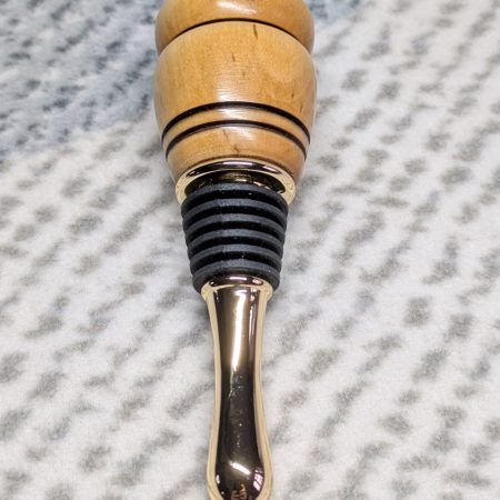 Hand turned birch bottle stopper with a gold plated teardrop base