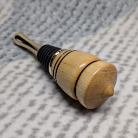 Hand turned birch bottle stopper with a gold plated teardrop base