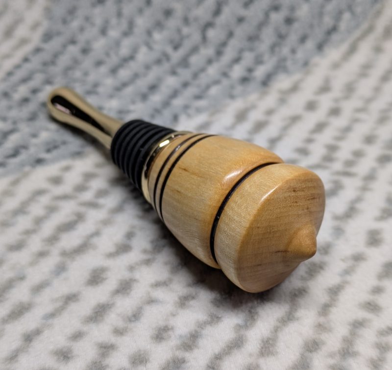 Hand turned birch bottle stopper with a gold plated teardrop base