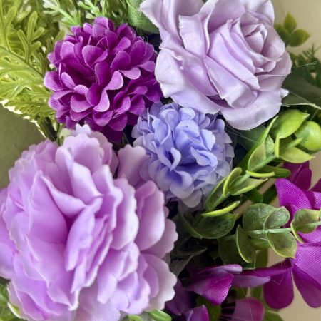 60cm Wreath with artificial flowers in subtle purple shades with green foliage
