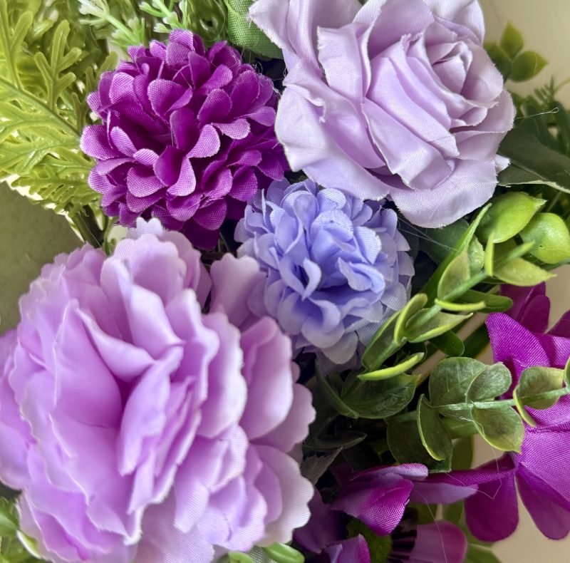 60cm Wreath with artificial flowers in subtle purple shades with green foliage