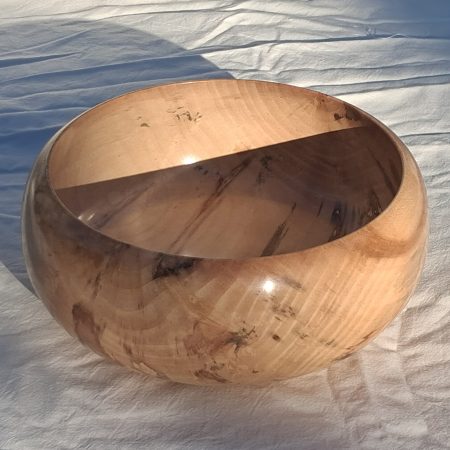 Decoratively shaped round bowl in natural spalted white poplar wood.