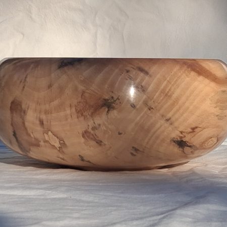 Decoratively shaped round bowl in natural spalted white poplar wood.