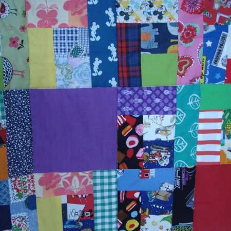 Handmade Quilt / Play Mat Multi Colours And Prints With A Navy Blue Backing