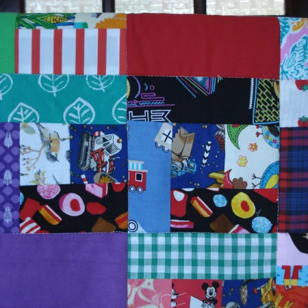 Handmade Quilt / Play Mat Multi Colours And Prints With A Navy Blue Backing