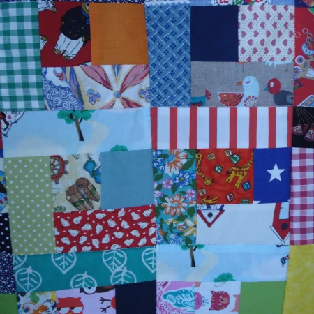 Handmade Quilt / Play Mat Multi Colours And Prints With A Navy Blue Backing