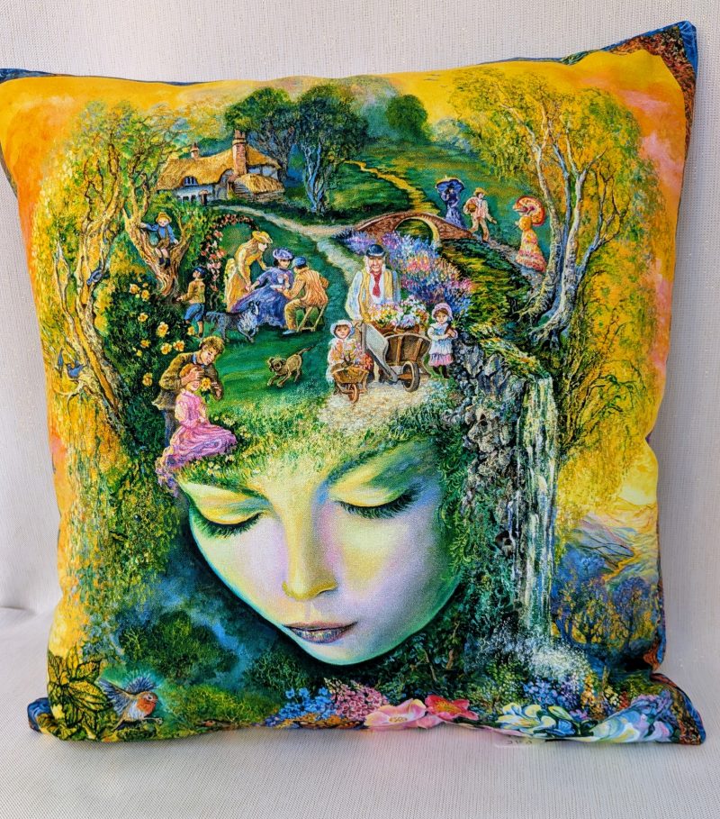 Summer garden fantasy art cushion within the face of Nature goddess showing a village green scene, flowers, butterflies and birds, colourful fantasy decorative pillow