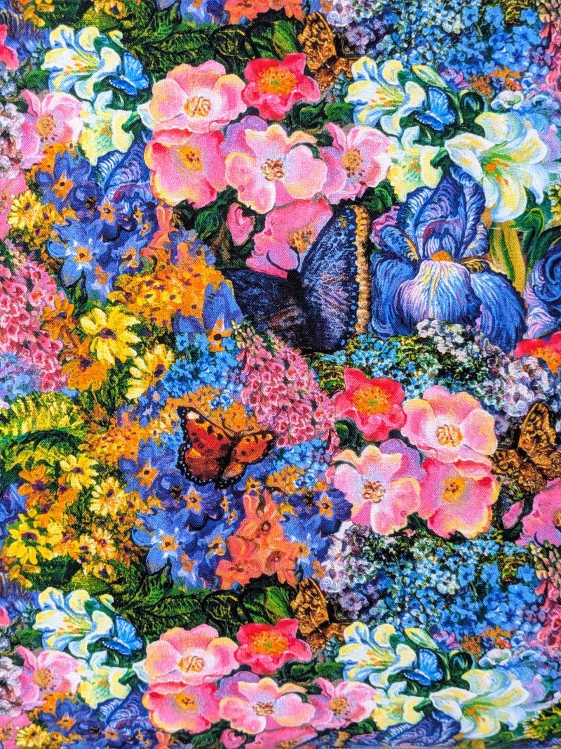 Close up of Summer Dreamscape Goddess 18" 45 cm cotton cushion cover showing cottage garden style flowers, butterflies and birds, colourful fantasy decorative pillow