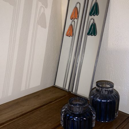 Stained glass effect mirrors with green and orange flowers.