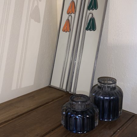 Stained glass effect mirrors with green and orange flowers.