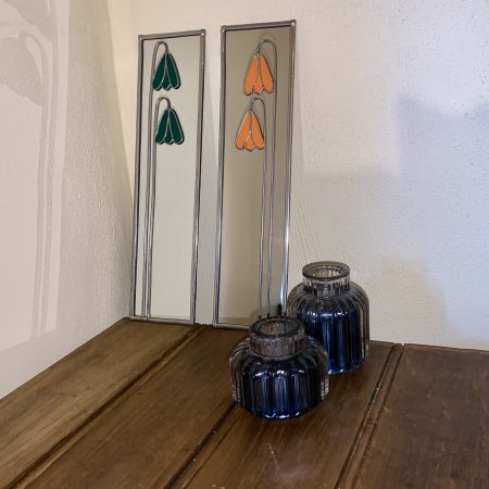 Stained glass effect mirrors with green and orange flowers.