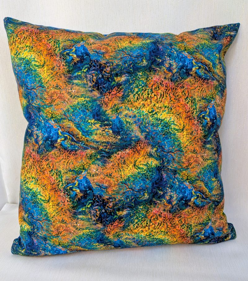 Reverse of Elemental Earth goddess cushion cover detailing the orange, blues, yellows and greens from the front cover