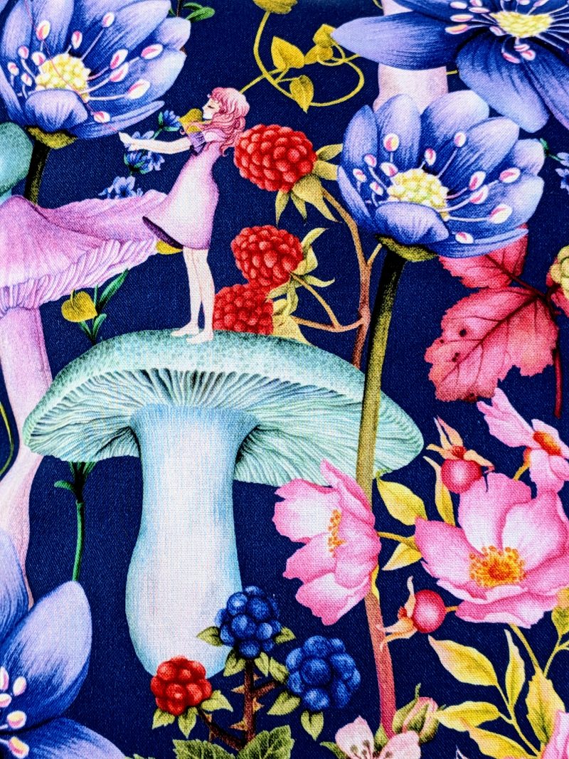 Detail of the reverse of the decorative 18" 45cm pillow cover with whimsical girl, mushroom, berries and large flowers on a navy blue botanical background.