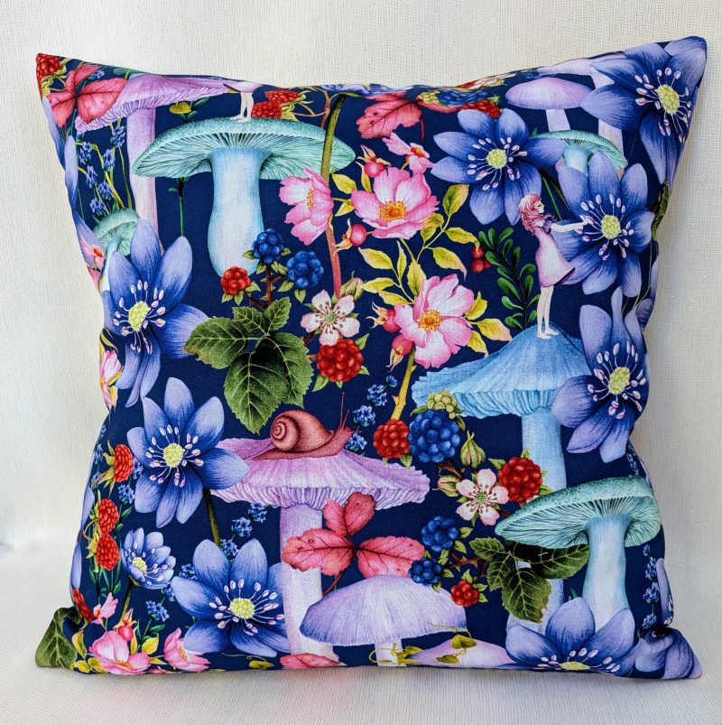Decorative 18" 45cm pillow cover with whimsical girl, mushrooms, berries and large flowers on a navy blue botanical background.