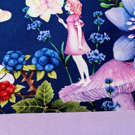 Detail showing the lining for the decorative cushion cover showing a girl standing on a mushroom holding a butterfly surrounded by flowers and floating butterflies on a navy background.