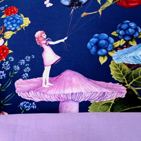 Detail of the lining for the Illustrated cushion cover featuring a girl standing on a mushroom holding berry shaped balloons surrounded by flowers and butterflies on a navy background.