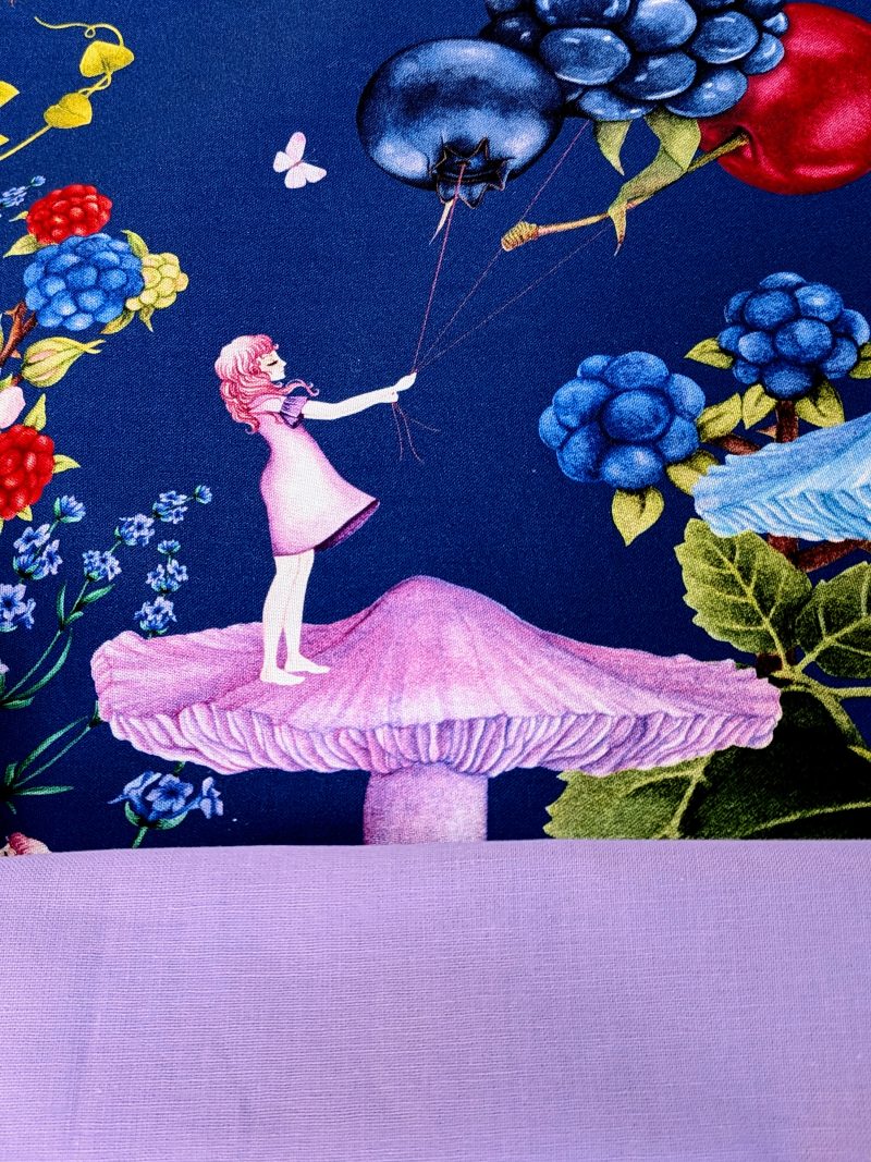 Detail of the lining for the Illustrated cushion cover featuring a girl standing on a mushroom holding berry shaped balloons surrounded by flowers and butterflies on a navy background.