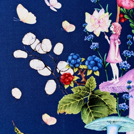 Detail of the front of the decorative cushion cover showing a girl standing on a mushroom holding a butterfly surrounded by flowers and floating butterflies on a navy background.
