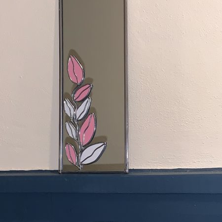 Stained glass effect Mirror with Art nouveau style pink and white leaf pattern.