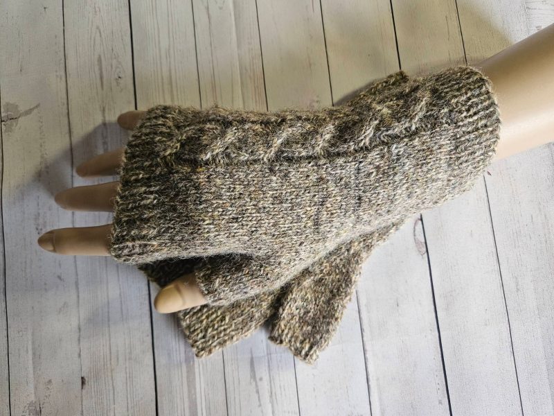 Handknitted fingerless mitts.