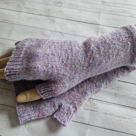 Handknitted fingerless mitts.