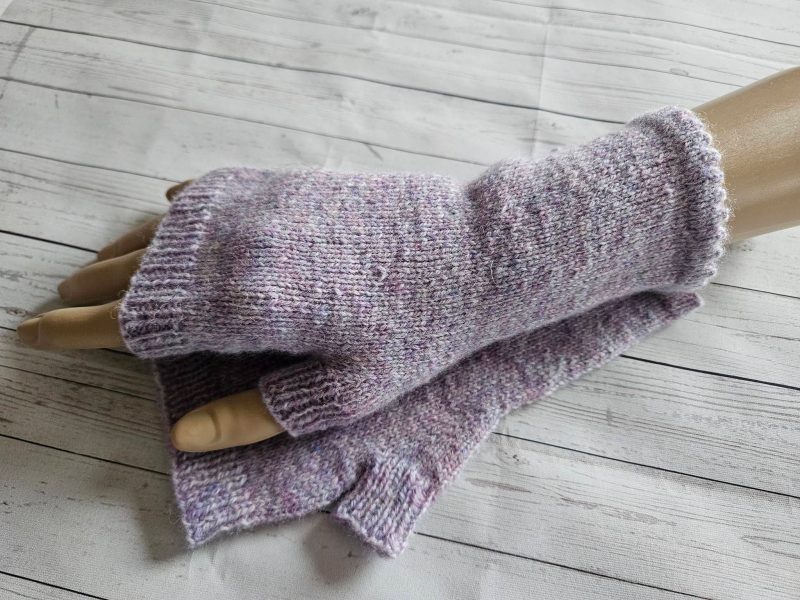 Handknitted fingerless mitts.