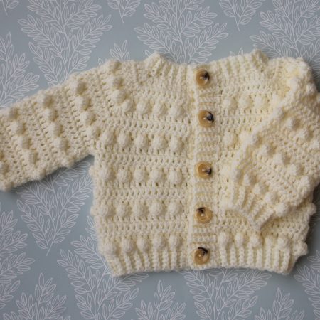 Crochet cream coloured cardigan featuring long sleeves, round neck and a bobble pattern throughout