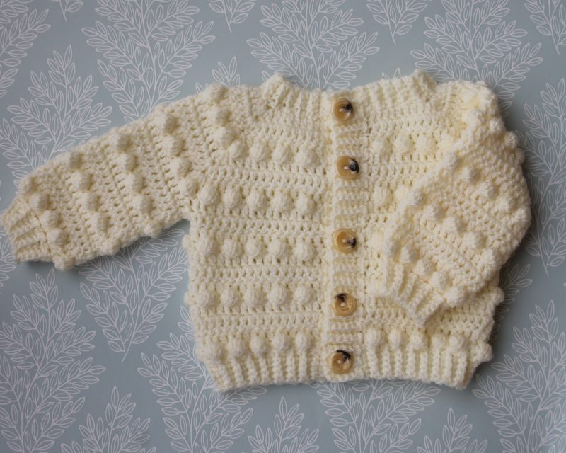 Crochet cream coloured cardigan featuring long sleeves, round neck and a bobble pattern throughout