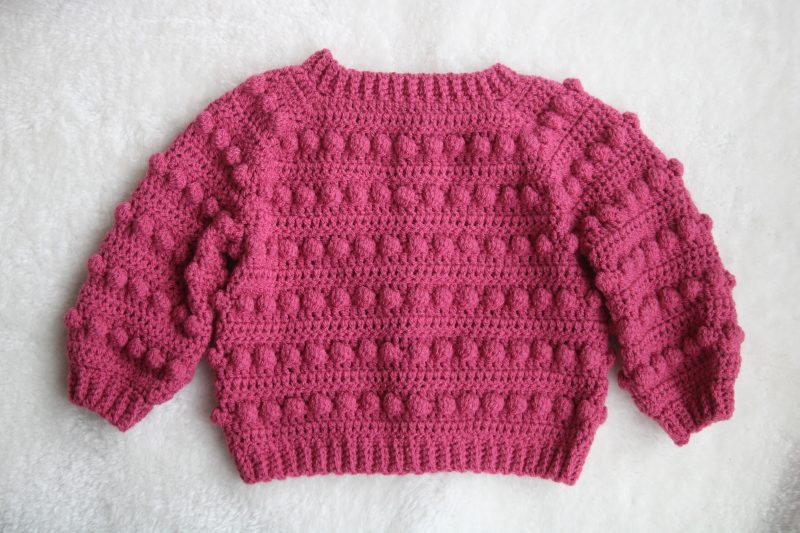 Back View of Crochet Bobble Cardigan in Raspberry Pink