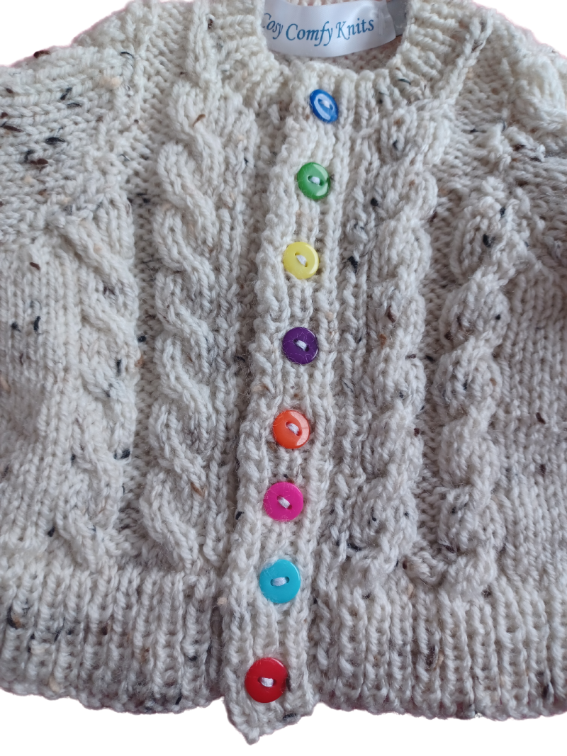Cabled cardigan in soft yarn giving a tweed look.