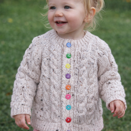 Cabled cardigan in soft yarn giving a tweed look.