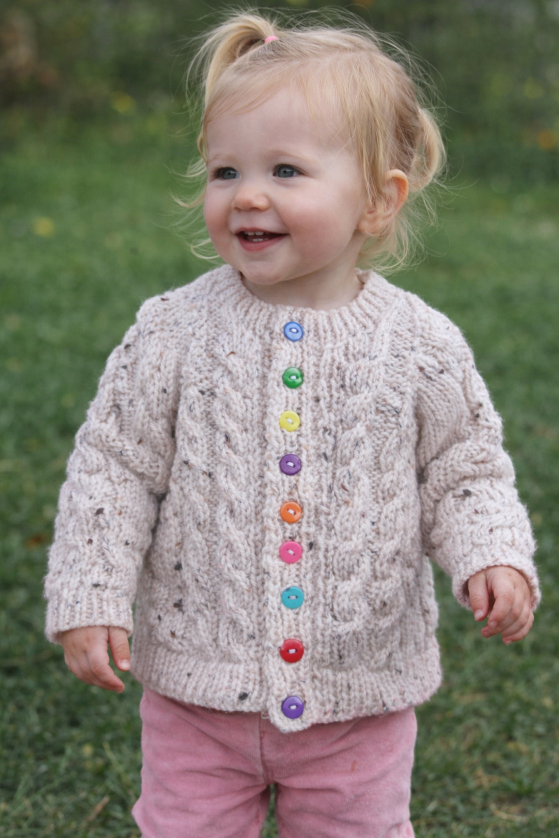 Cabled cardigan in soft yarn giving a tweed look.