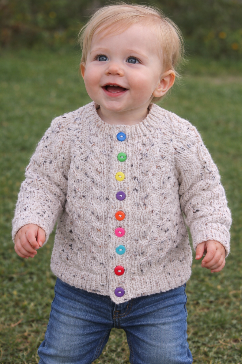 Cabled cardigan in soft yarn giving a tweed look.