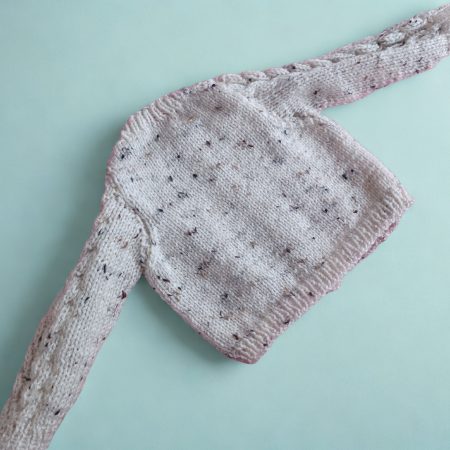 Cabled cardigan in soft yarn giving a tweed look.