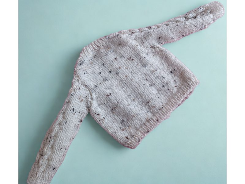 Cabled cardigan in soft yarn giving a tweed look.