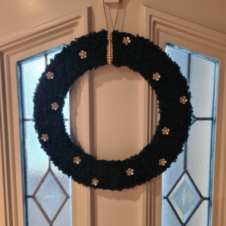 Dark green yarn wrapped wreath