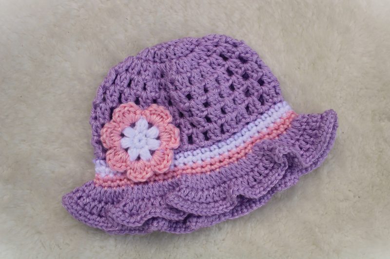Crochet Lilac Summer Hat for a Baby Girl with a Ruffle Brim and Flower Decoration